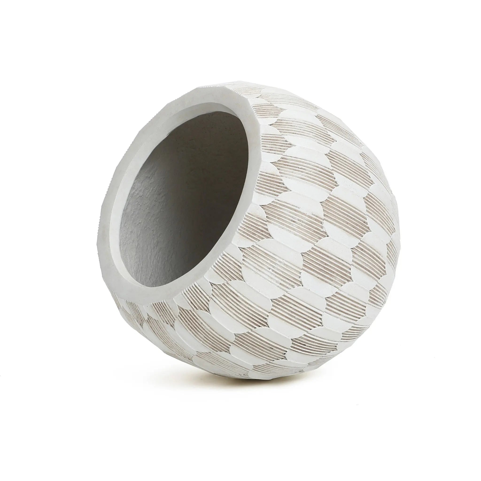The LuxenHome White and Beige Geometric Patterned Round Planter, 11.81 H, features a textured ceramic design with diamond shapes and is crafted from durable MgO and fiberglass, elegantly tilted against a plain white background.