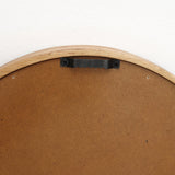 Back of a round rubberwood framed mirror featuring a black metal hanging bracket and two screws, complemented by a non-slip back mounting.