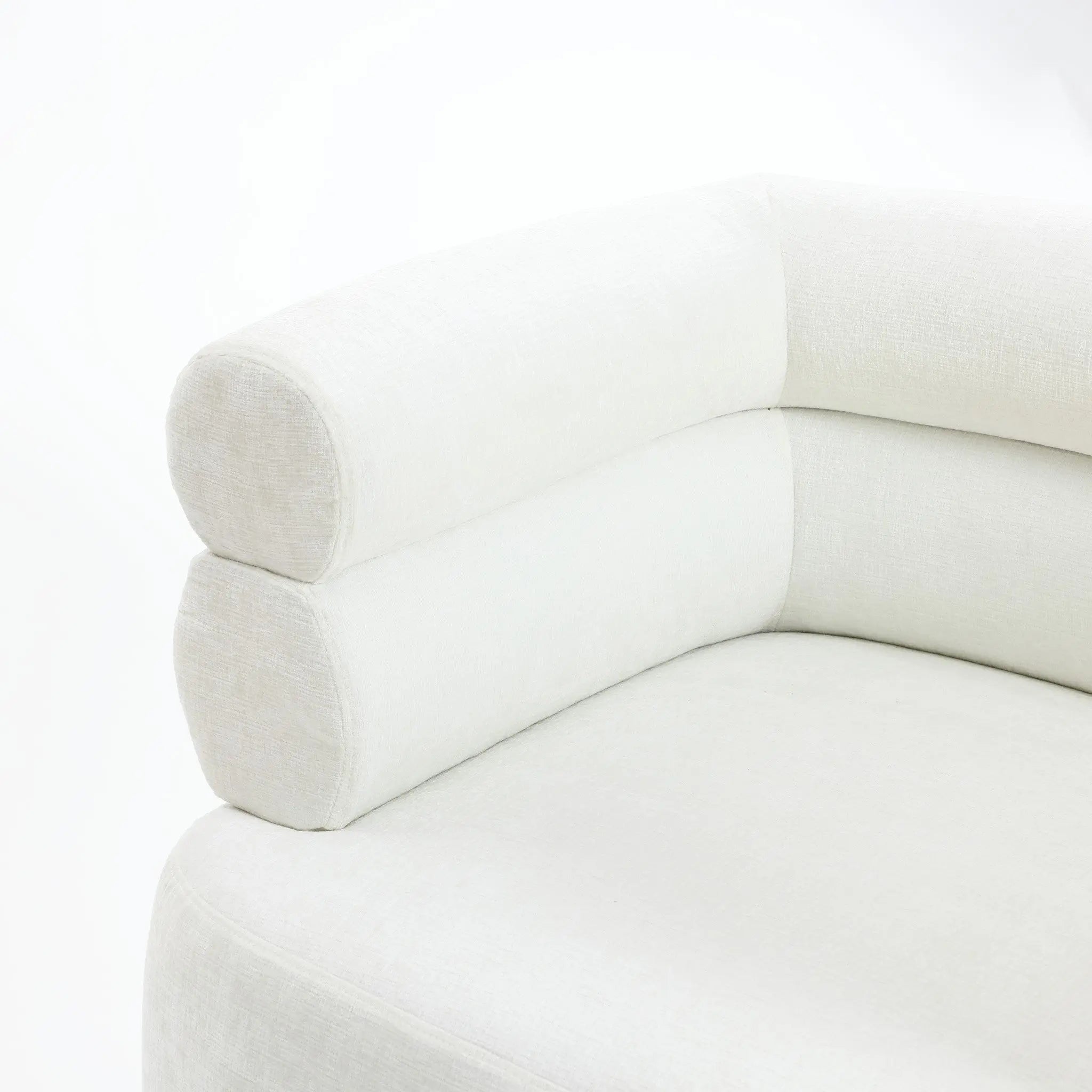 A close-up of the Tia ivory barrel accent chair by LuxenHome reveals a modern look with rounded corners, cylindrical armrests, and wooden ball legs. Its soft fabric texture enhances the double bolster backrest, and its clean, minimalist lines express contemporary style.