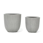 Two gray, textured cylindrical planters with a subtle modern striped pattern sit side by side on a white background, perfect for enhancing your home and garden.
