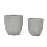Two gray, textured cylindrical planters with a subtle modern striped pattern sit side by side on a white background, perfect for enhancing your home and garden.
