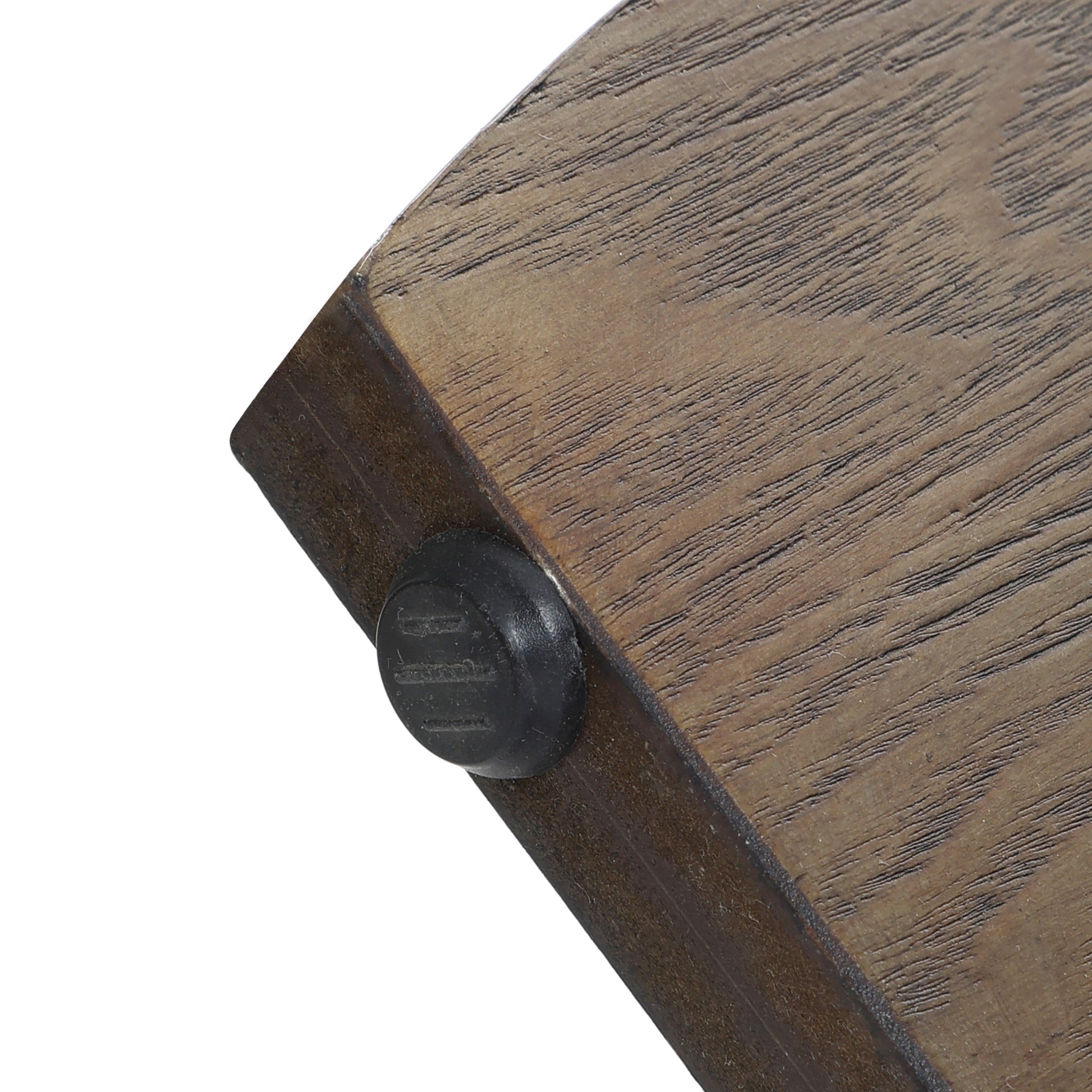 Close-up of a wooden surface, perhaps from a walnut veneer table, featuring a rounded black plastic stopper on its edge—likely part of an elegant mid-century modern side table.