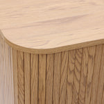 Buffet cabinet sideboard, close-up of the corner of a mid century storage cabinet with a light oak finish and vertical grain pattern, highlighting detailed craftsmanship.