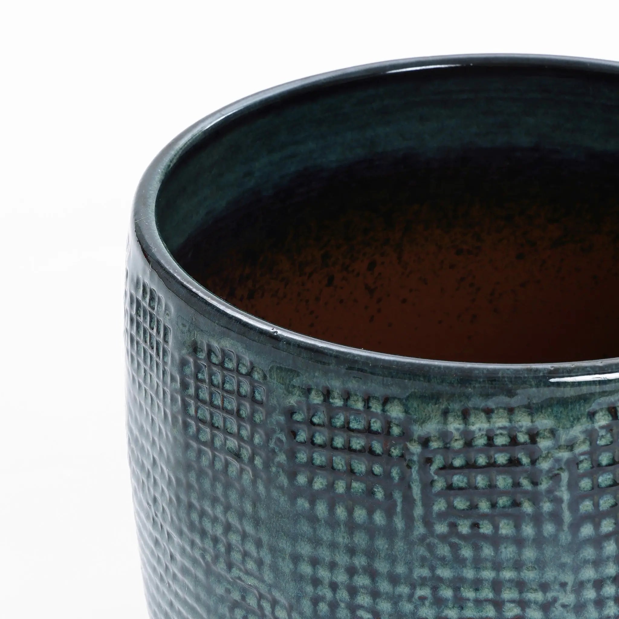 Close-up of a LuxenHome Marina gray glazed planter, 11.22 h, with a textured ceramic surface and grid-like design. The round-bottom reveals its interior in gradient darker shades, offering an intriguing look.