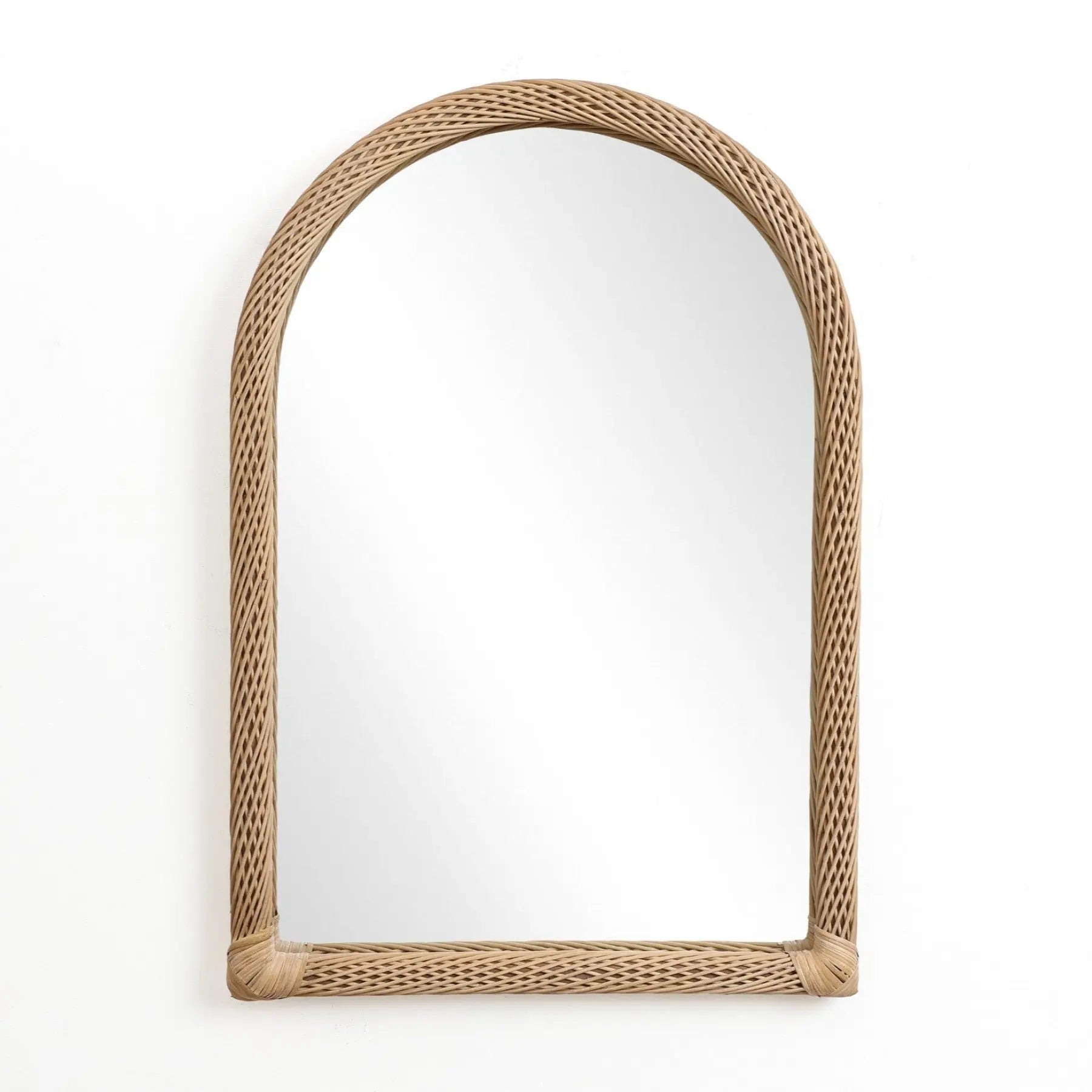 A decorative hanging mirror with an arched rectangular design features a rattan frame, elegantly mounted against a plain white background.