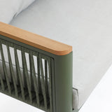 Close-up of a modern chair with a durable aluminum alloy frame and light gray plush cushion, featuring wooden armrests. The design includes woven details on the sides.