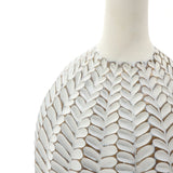 Close-up of a LuxenHome Modern geometric pattern resin tall trumpet vase, 23.5 h, showcasing intricate leaf patterns. It features a smooth, glossy surface with an antique effect enhancing the delicate design against the white background.