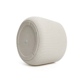 A LuxenHome ribbed round planter in light gray is on its side against a white background. Featuring a modern, minimalist cylindrical design, it measures 10.63 h with a flat base and small round central indentation.