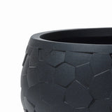Close-up of a durable black LuxenHome tabletop planter, 17.5 w, showcasing a geometric beehive pattern with interlocking pentagon shapes and a smooth matte finish.