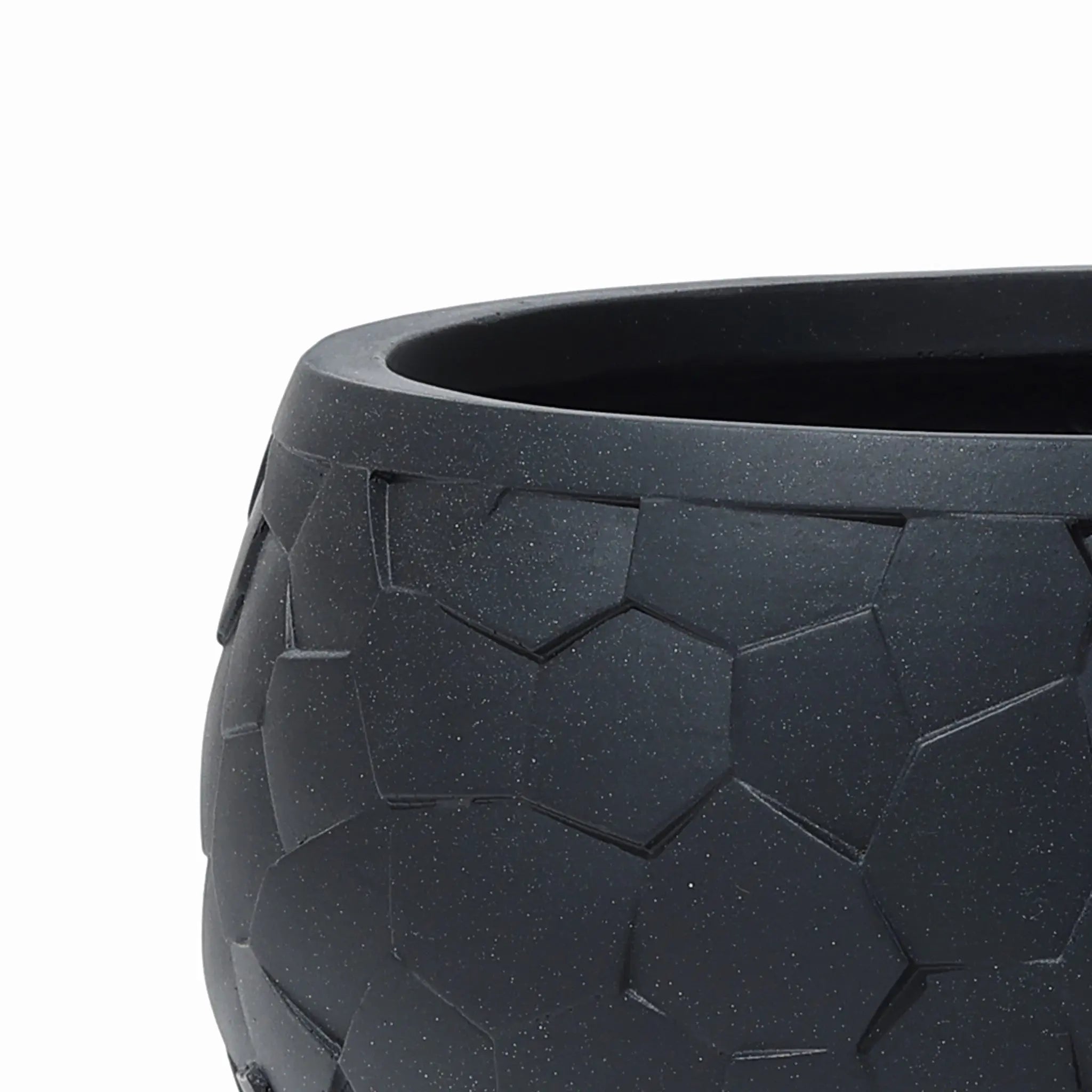 Close-up of a durable black LuxenHome tabletop planter, 17.5 w, showcasing a geometric beehive pattern with interlocking pentagon shapes and a smooth matte finish.
