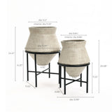 Two vintage distressed style beige cachepot planters on black stands, perfect for enhancing your indoor space decor. Each planter boasts detailed measurements for diameter and height, ensuring a perfect fit for any room.
