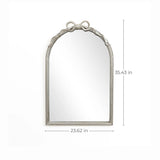 The Ribbon Wall Mirror features an arched silhouette with a decorative top, embodying a modern romantic style. Its dimensions are 35.43 inches high and 23.62 inches wide, adding elegance to any space.