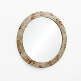 A round wall-mounted mirror with a poplar burl veneer frame elegantly accents a white background.
