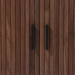 The LuxenHome Aria 2-Door Tambour Accent Cabinet features a close-up of its dark oak finish with vertical grooves and sleek black handles, enhancing its luxurious Mid-Century Modern appeal.