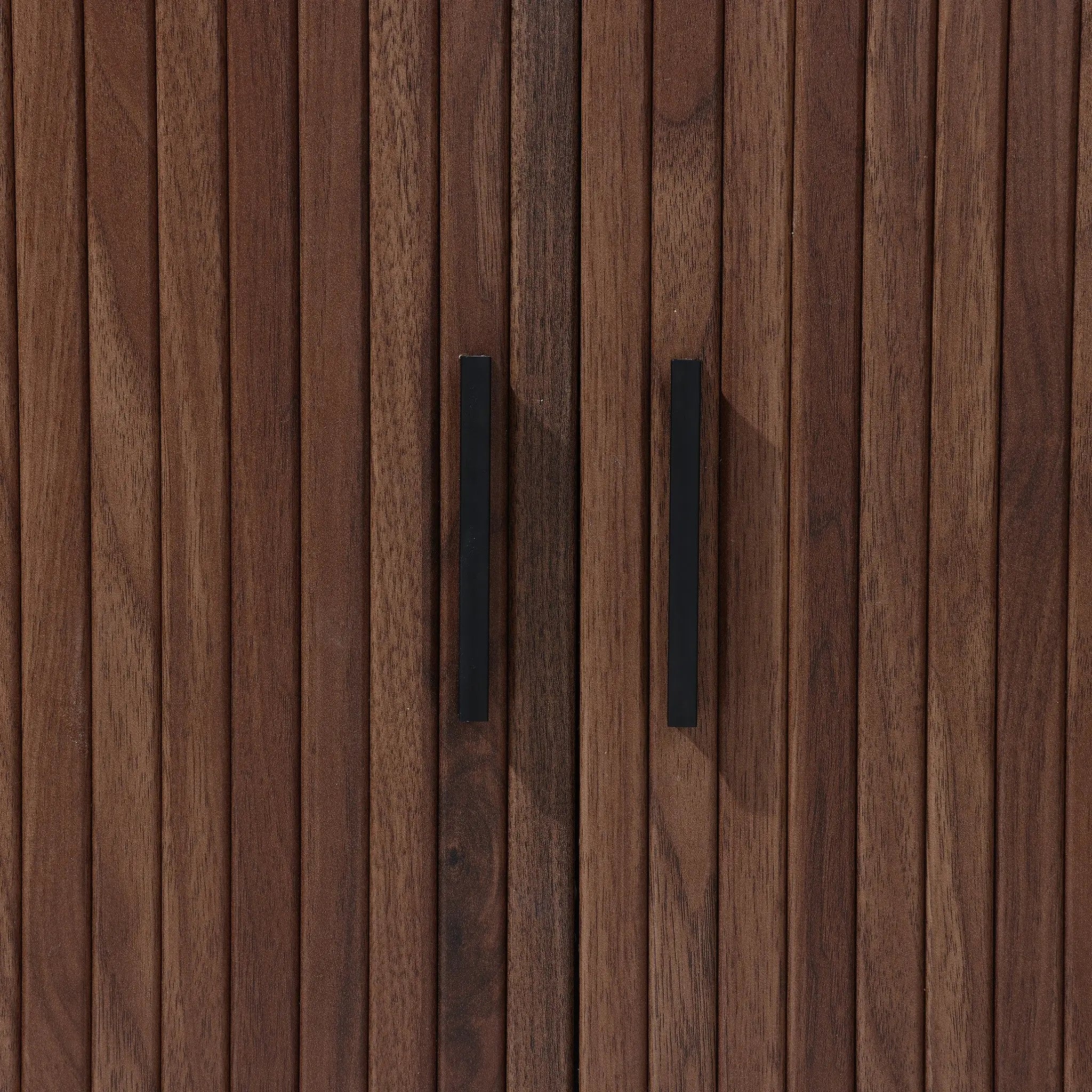 The LuxenHome Aria 2-Door Tambour Accent Cabinet features a close-up of its dark oak finish with vertical grooves and sleek black handles, enhancing its luxurious Mid-Century Modern appeal.