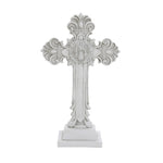 A decorative white cross with ornate patterns and a medallion at the center on a square base, perfect for religious occasions or as a symbol of the Christian faith.