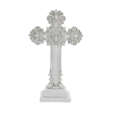A decorative white cross with ornate patterns and a medallion at the center on a square base, perfect for religious occasions or as a symbol of the Christian faith.