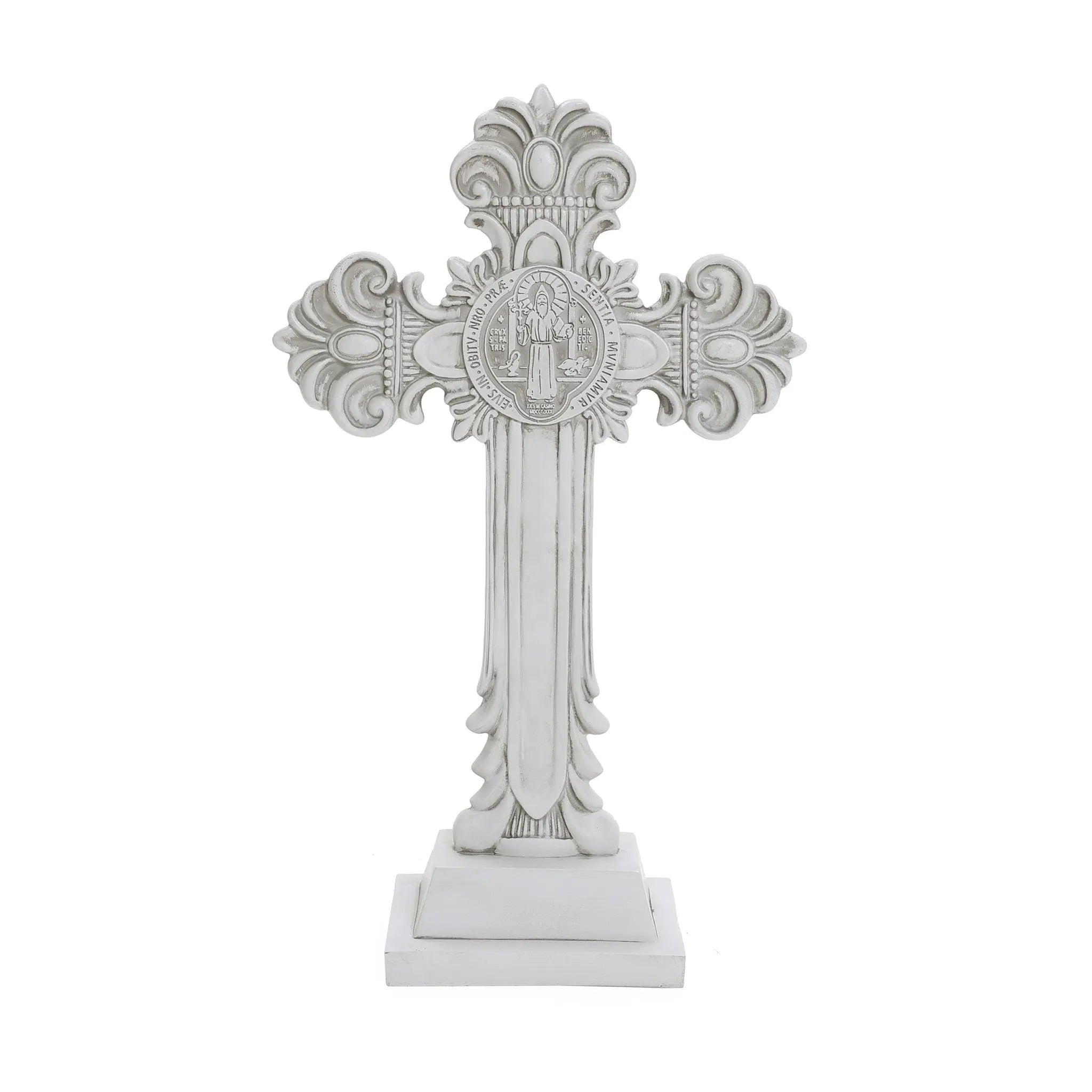 A decorative white cross with ornate patterns and a medallion at the center on a square base, perfect for religious occasions or as a symbol of the Christian faith.