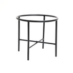 A black, round metal table with four legs and a crossbar support adds a touch of vintage distressed style to any indoor space decor.