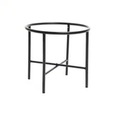 A black, round metal table with four legs and a crossbar support adds a touch of vintage distressed style to any indoor space decor.