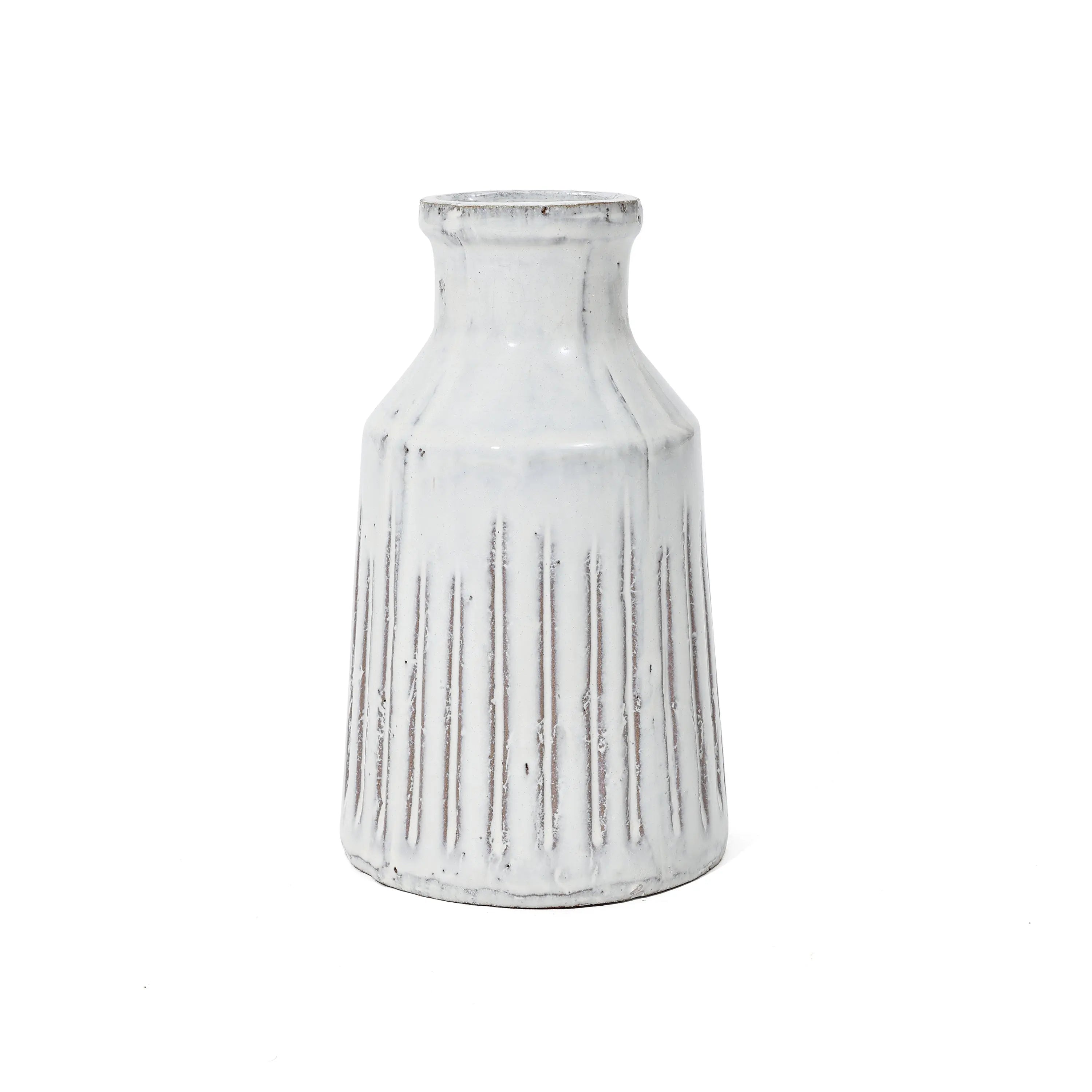 A white ceramic vase exuding rustic charm with vertical ridges and a narrow neck, reminiscent of a vintage design.