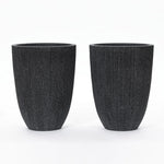 Two black, concrete-textured cylindrical planters with a slight taper towards the base, placed side by side on a white background. These UV and weather-resistant planters are perfect for both indoor and outdoor settings.