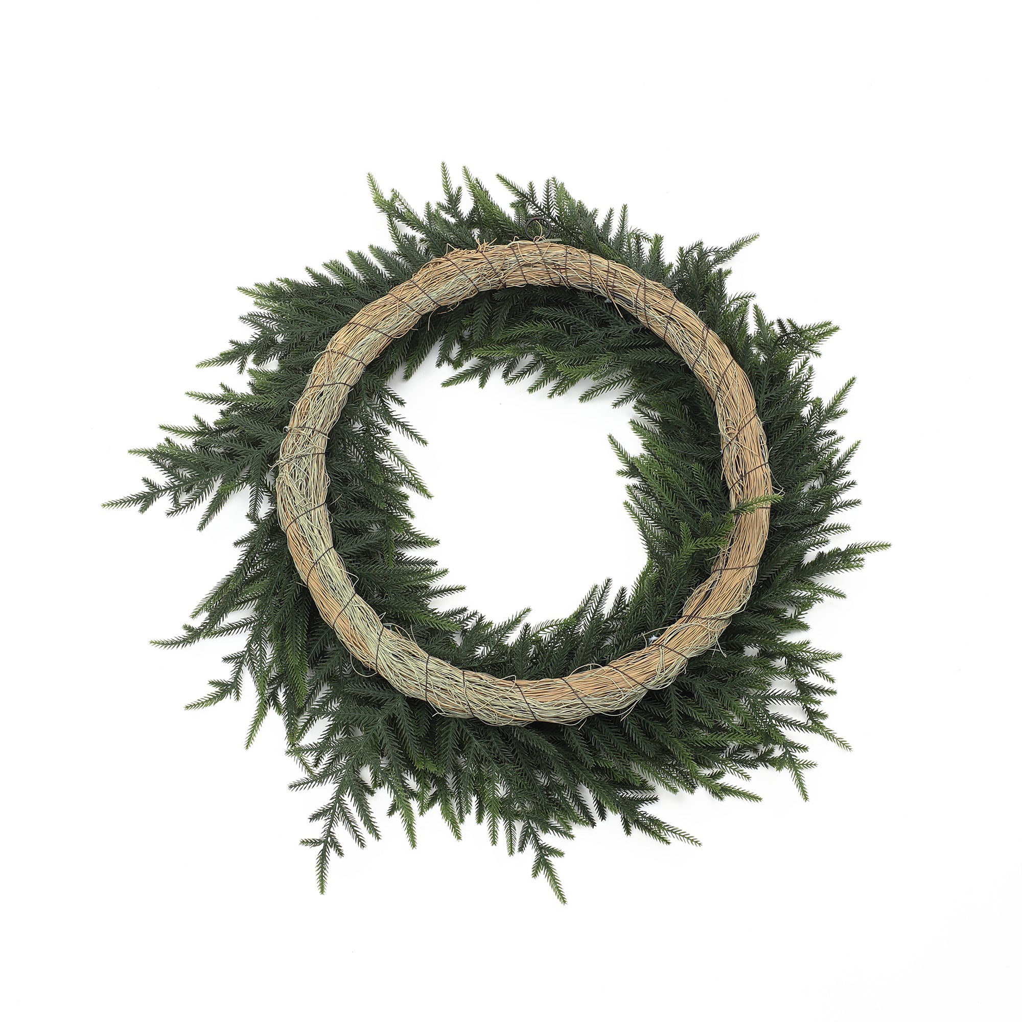 Circular artificial wreath made of brown twine ,green pine branches, displayed on white background.