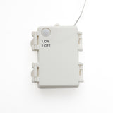 White rectangular electrical box with round sensor,labeled options: 1. ON, 2. OFF. A wire extends from the top.