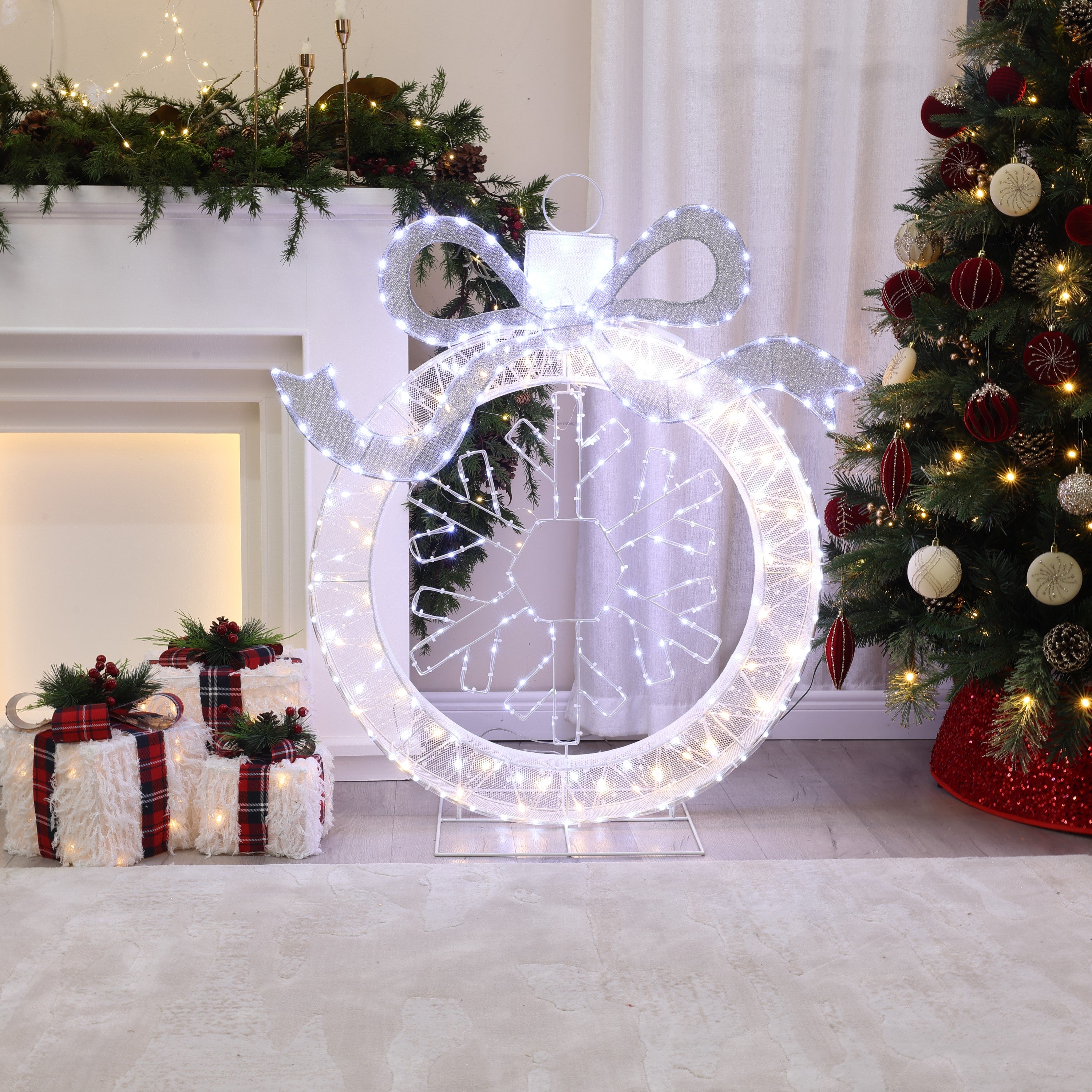 Pre-lit led wreath with a bow stands next decor christmas tree,wrapped presents in festively adorned living room.