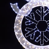 Close-up of illuminated snowflake decor with white led lights ,festive led wreath striking.