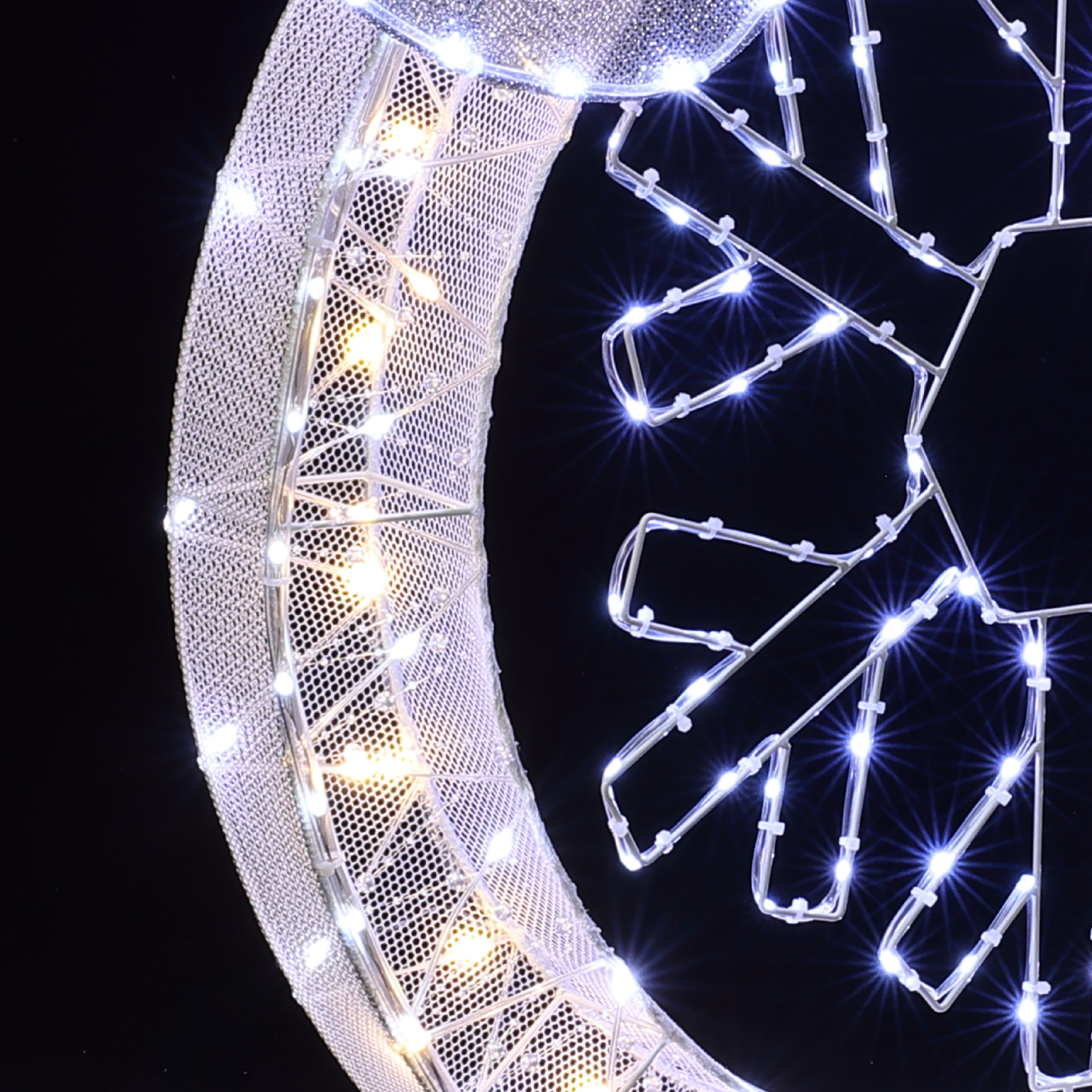 Close-up of a decor illuminated structure white led lights arranged in geometric patterns, modern led wreath.