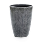The LuxenHome Sea Gray Ripples Glazed Tall Ceramic Planter stands 17 high, showcasing an elegant design with a wood grain-like textured surface and vertical black-and-white stripes for a modern flair against its plain white background.