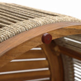 Close-up of a wooden chair crafted from acacia wood, featuring a curved frame and hand-woven rope seat. A small round red accent is attached to the frame, making it perfect for both indoor and outdoor settings.