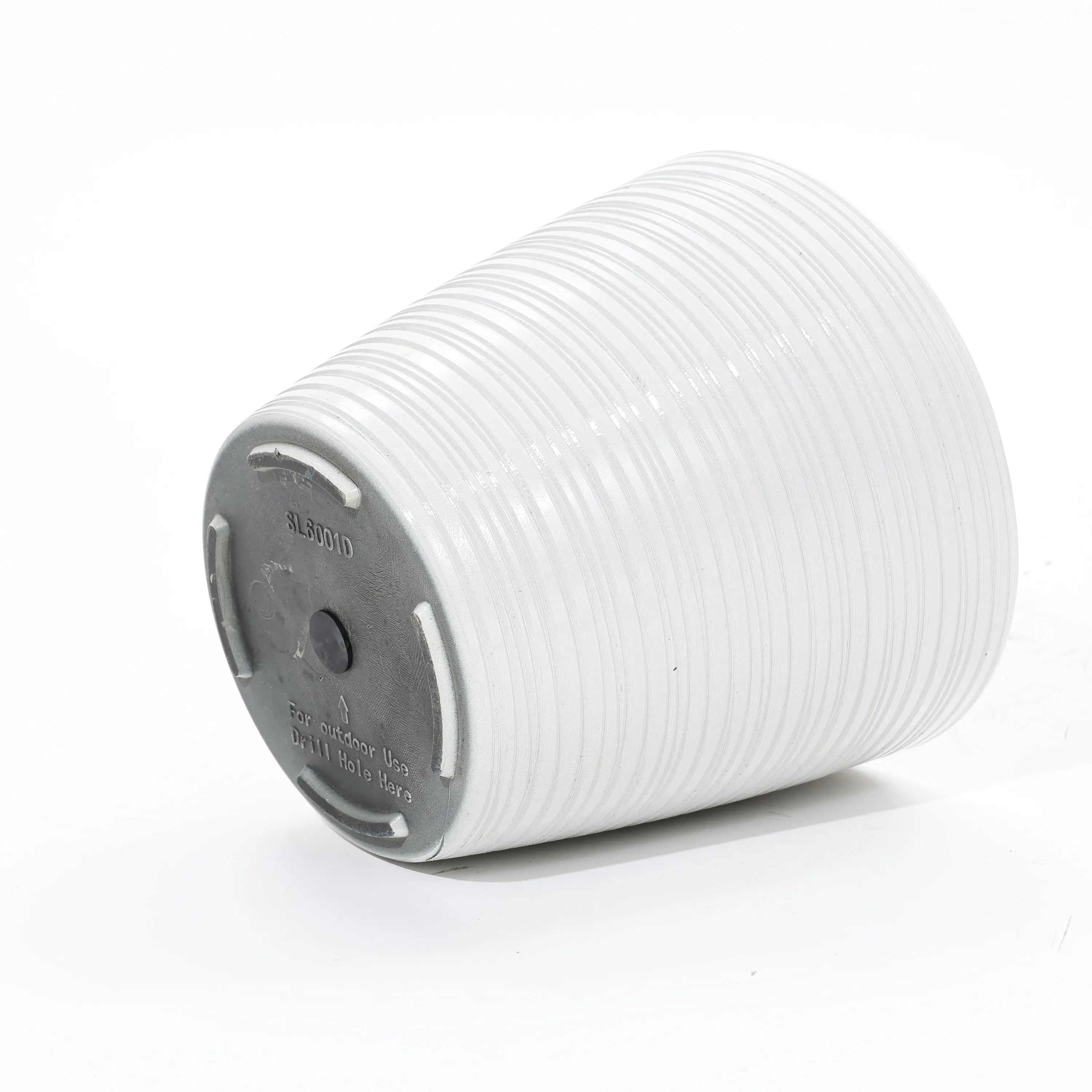 A decorative, weather-resistant ribbed ceramic pot lies elegantly on its side, showcasing a sturdy circular base perfect for both indoor and outdoor use.