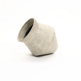 A textured, light gray cachepot planter in a vintage distressed style is tilted on its side against a plain white background.