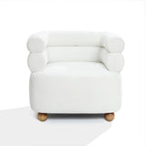 The Tia ivory barrel accent chair from LuxenHome boasts a minimalist design with cushioned rounded arms, a double bolster backrest, and sleek wooden ball legs, set against a plain white background.