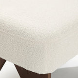 The LuxenHome Lorenzo boucle upholstered armless accent chair features a textured, soft wool-like white fabric on a cushioned seat with wooden angled legs, exuding mid-century allure.