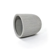 A gray, ribbed, cylindrical concrete planter with a modern striped pattern lies on its side against a white background, perfect for adding a contemporary touch to your home and garden.
