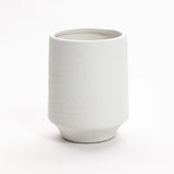 A white terracotta vase with a textured ceramic finish features a cylindrical shape and slightly tapered base, standing at 12 inches tall. Ideal for both indoor and outdoor settings, its beautifully displayed against a plain white background.