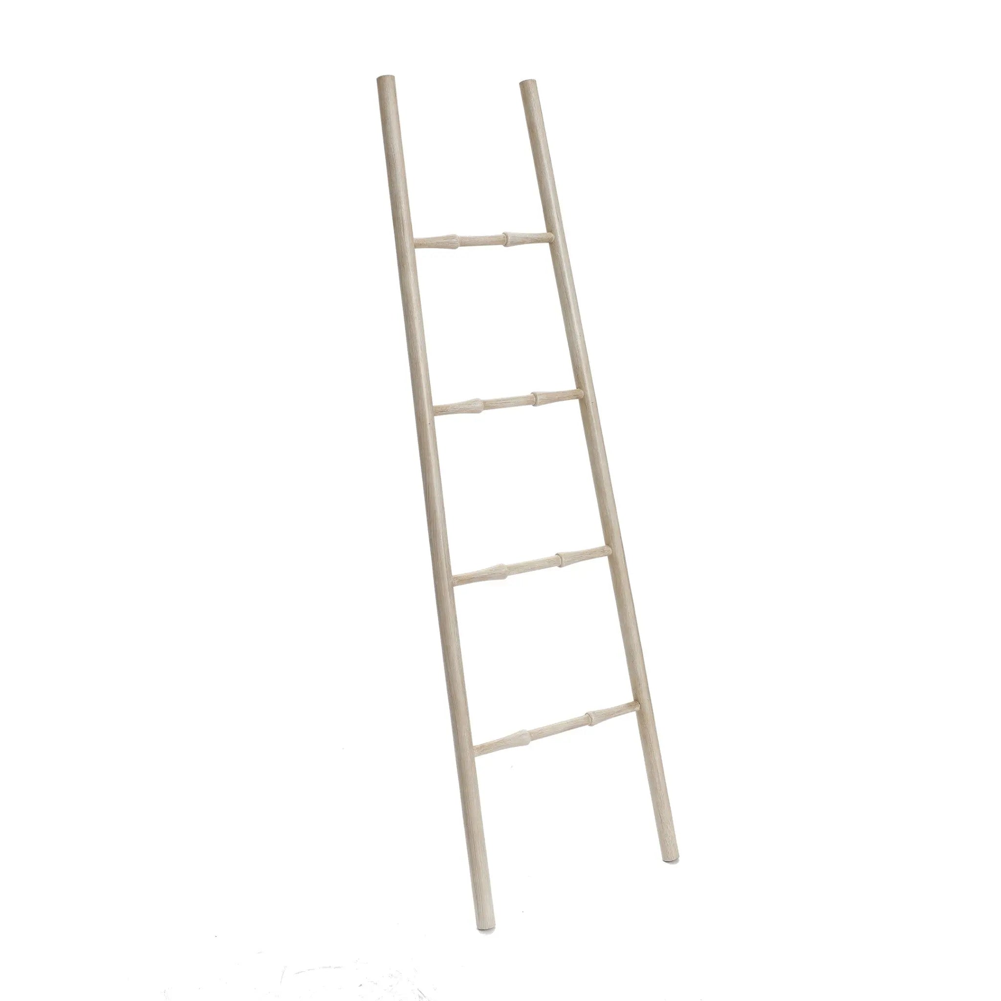 A rustic blanket ladder crafted from birch wood, featuring four rungs, leans elegantly against a white background.