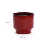 The LuxenHome Burgundy red glazed round ceramic planter, 10.83 inches tall, features a vertical stripe design, perfect for showcasing your favorite plants.