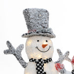 A lighted snowman with a black and white checkered scarf and tall frosted hat, smiling and raising both arms, makes a charming snowman decoration against a white background.