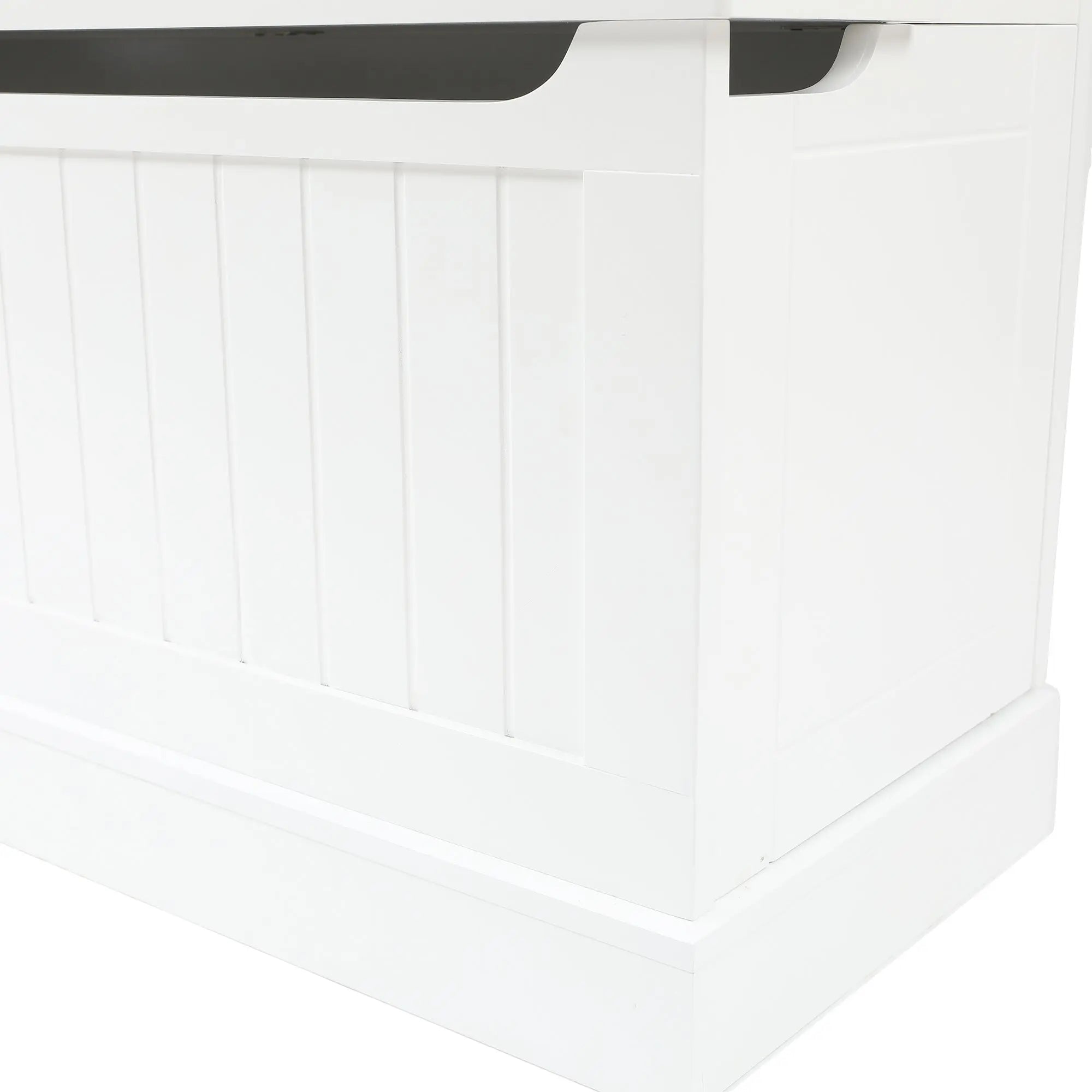 A close-up view of a white wooden storage bench with a paneled front and a slightly open lid.