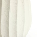Close-up of a modern white vase with a textured surface, featuring vertical ridges and subtle scratches, perfect as an artistic centerpiece for minimalist home decor.