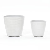 Two decorative planters with a ribbed design stand side by side against a white background. These versatile pieces come in different sizes and are perfect for both indoor and outdoor use, adding style to any space.