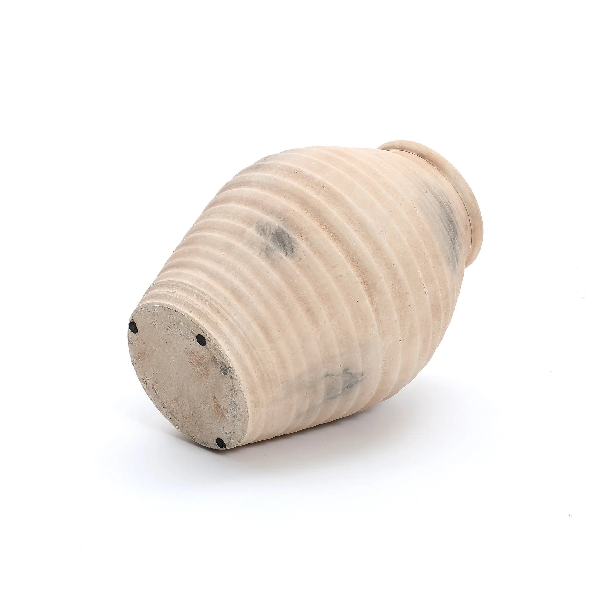 The LuxenHome Rustic beige ribbed terracotta urn vase, 13.2 h, reminiscent of an ancient amphora, is displayed on its side. Its handcrafted surface features patches of discoloration for a rustic look. The plain white background accentuates the ribbed texture and elegant form of this unique piece.