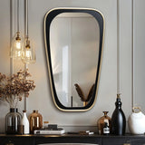 A modern living room featuring an elongated mirror for distortion-free viewing, pendant lights, vases, books, and a small sculpture elegantly arranged on a shelf.