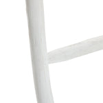 Close-up of a rustic, white-painted wooden blanket ladder with visible grain and texture, embodying rustic charm.