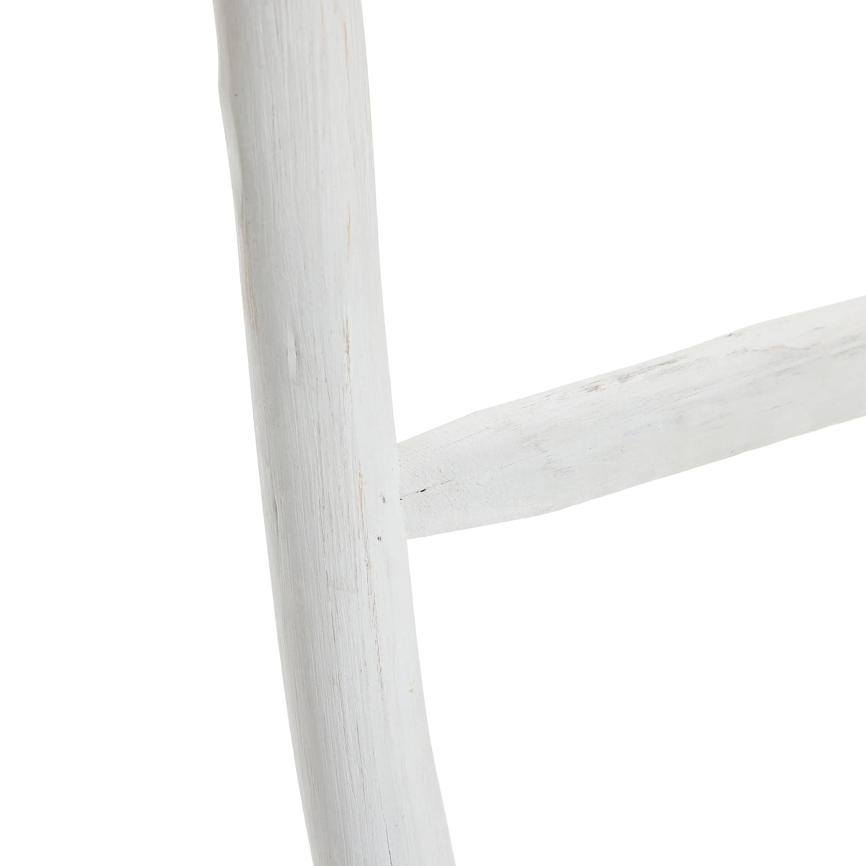 Close-up of a rustic, white-painted wooden blanket ladder with visible grain and texture, embodying rustic charm.