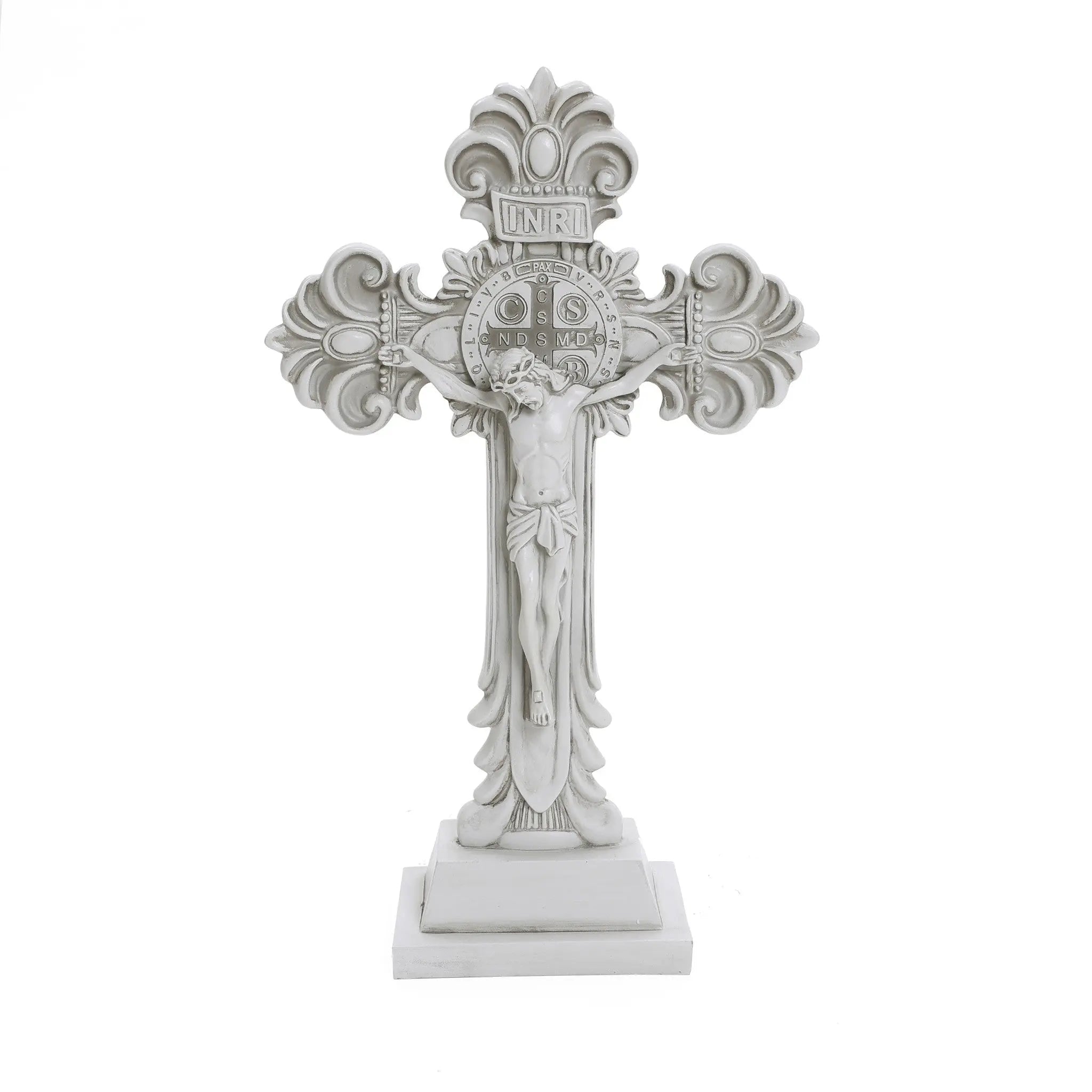 A decorative white crucifix, embodying the Christian faith, features an intricate design with a central figure of Jesus, elegantly standing on a rectangular base—perfect for religious occasions.